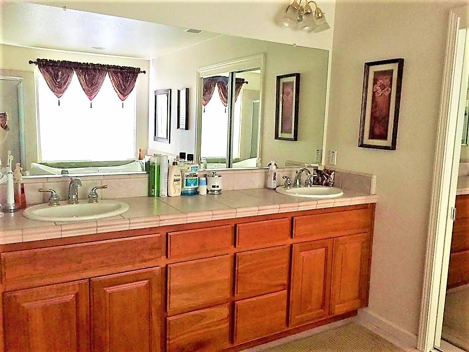3532 Keystone Loop Discovery Bay, CA 94505 - Photo 19 of 37 a bathroom with a granite countertop double vanity sink mirror and