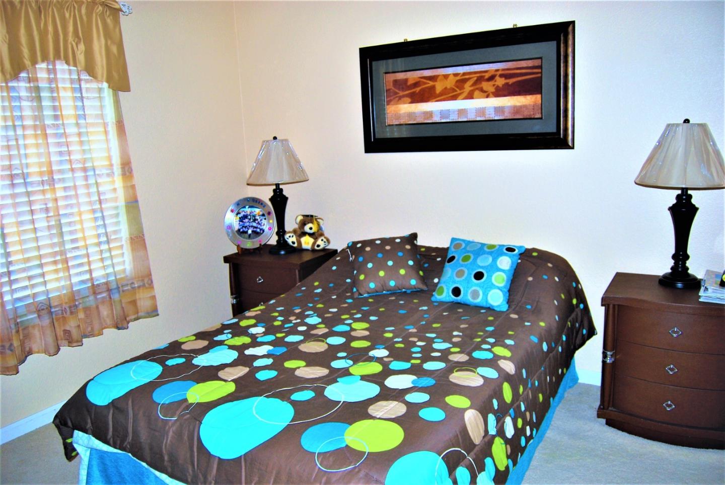 3532 Keystone Loop Discovery Bay, CA 94505 - Photo 22 of 37 a bedroom with a bed and a lamp on dresser