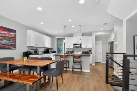 a kitchen with stainless steel appliances kitchen island granite countertop a refrigerator and microwave