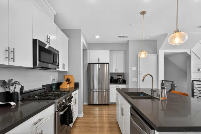 a kitchen with a sink stove and refrigerator