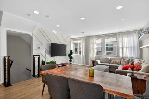a living room with furniture and a kitchen view