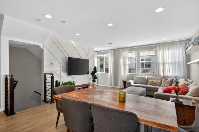 a living room with furniture and a kitchen view