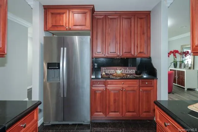 a kitchen with stainless steel appliances granite countertop a refrigerator and a stove top oven