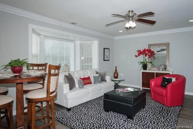 a living room with furniture chandelier and a window