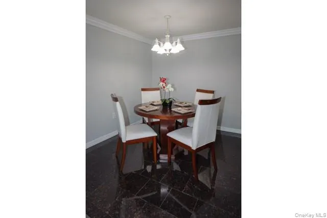 a dining room with furniture and chandelier