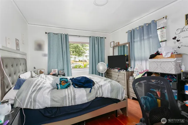 a bedroom with two beds and a window