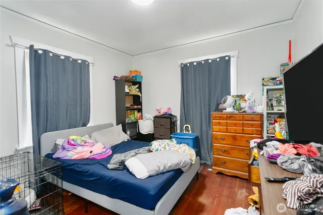 a bedroom with a bed and a tv