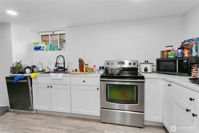 a kitchen with a stove and a microwave