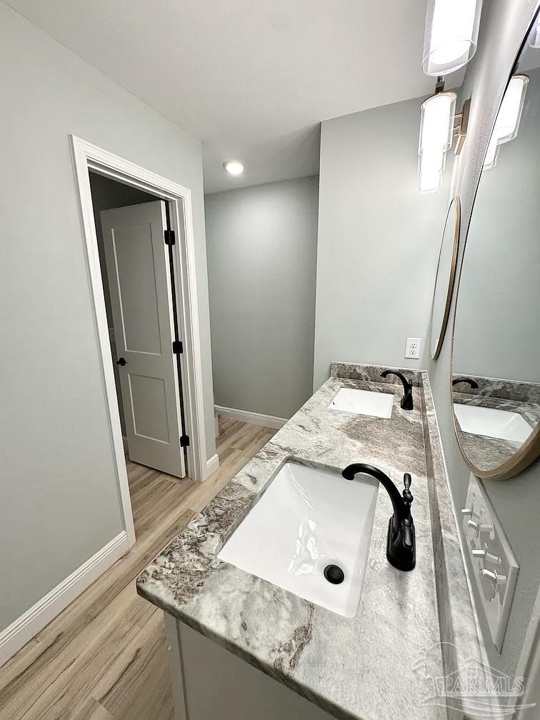 1910 West Kingsfield Road Cantonment, FL 32533 - Photo 3 of 8 a bathroom with a granite countertop sink and a mirror