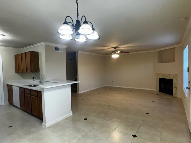 an empty room with a ceiling fan and a fireplace