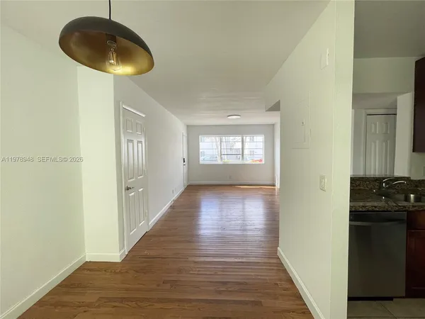 a view of a kitchen from a hallway