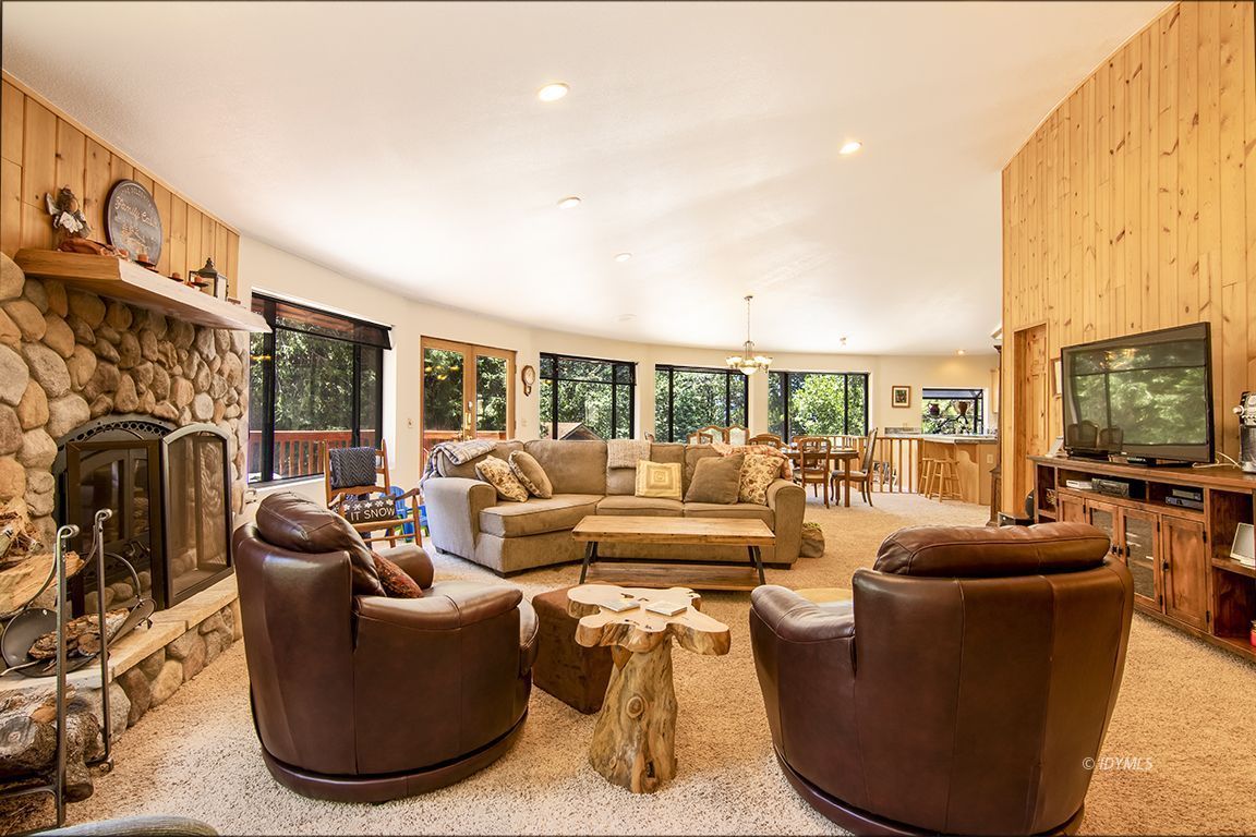 24625 Baldy Road Idyllwild, CA 92549 - Photo 12 of 80 a living room with fireplace furniture and a flat screen tv