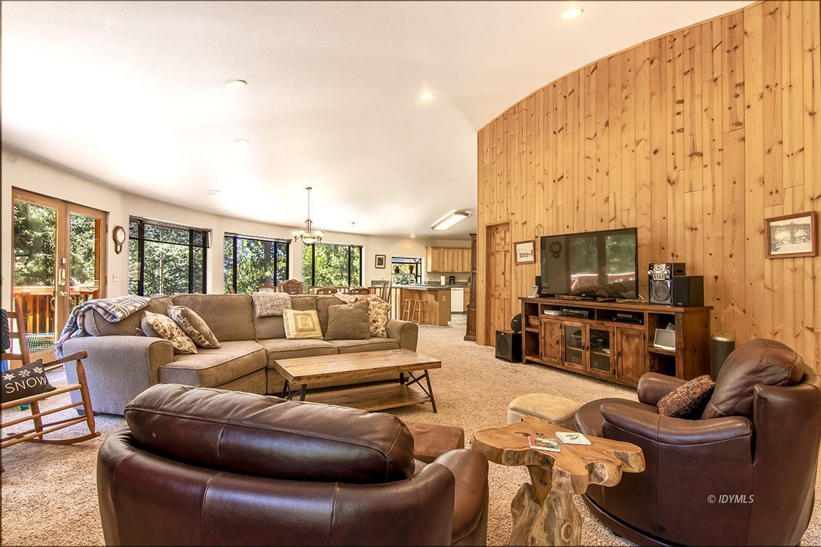 24625 Baldy Road Idyllwild, CA 92549 - Photo 13 of 80 a living room with furniture a flat screen tv and a floor to ceiling window