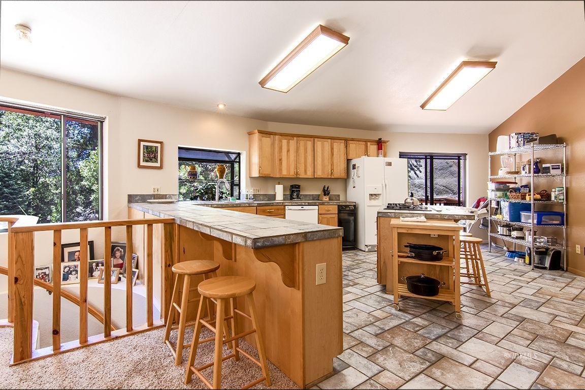 24625 Baldy Road Idyllwild, CA 92549 - Photo 21 of 80 a kitchen with stainless steel appliances a stove a sink dishwasher and a refrigerator