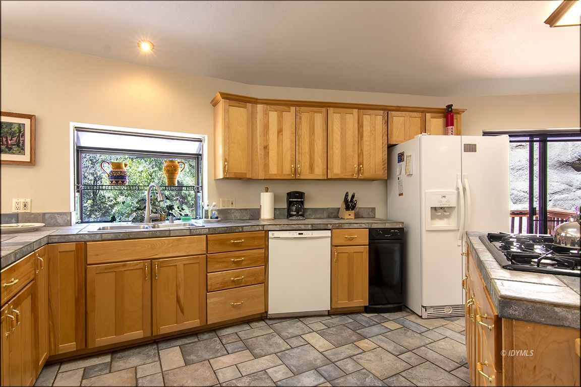 24625 Baldy Road Idyllwild, CA 92549 - Photo 25 of 80 a kitchen with a refrigerator a stove a sink and a window