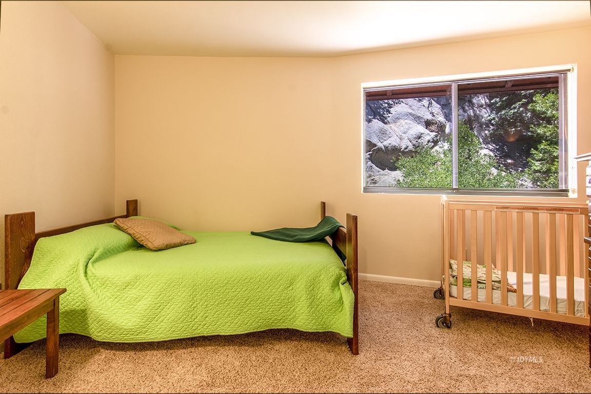 24625 Baldy Road Idyllwild, CA 92549 - Photo 31 of 80 a bedroom with a bed and a painting on the wall