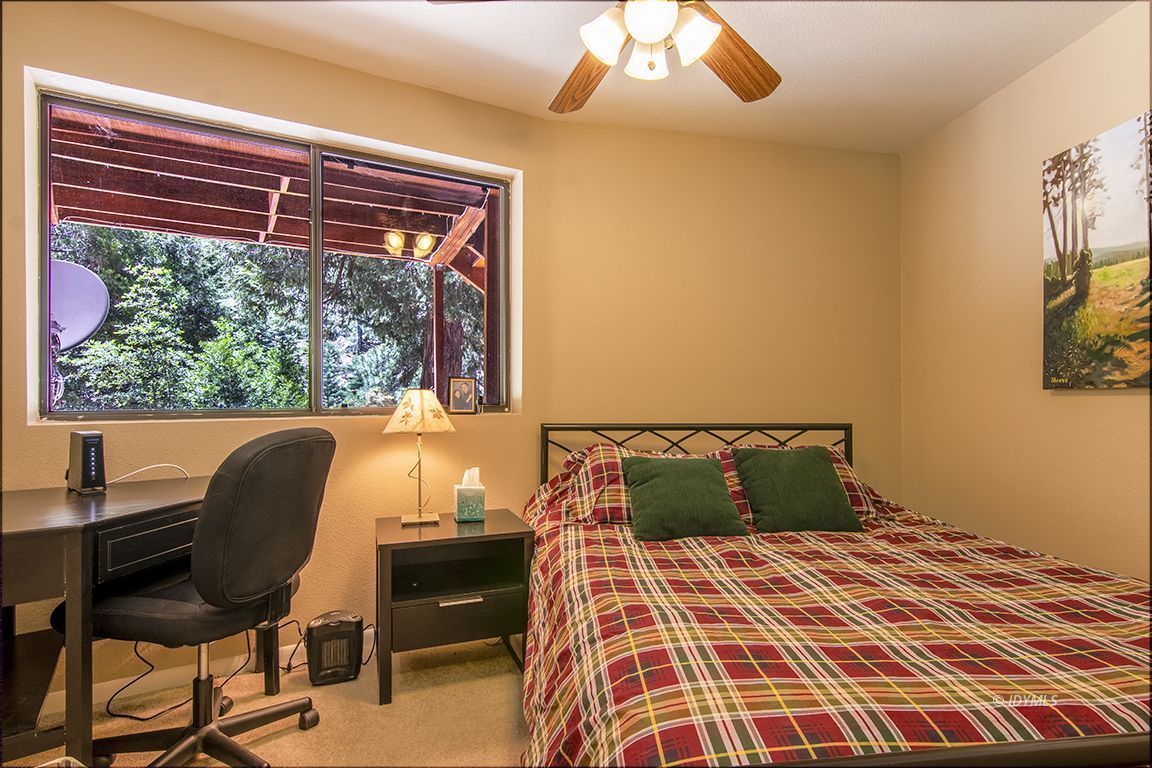 24625 Baldy Road Idyllwild, CA 92549 - Photo 46 of 80 a bedroom with a bed and a chair