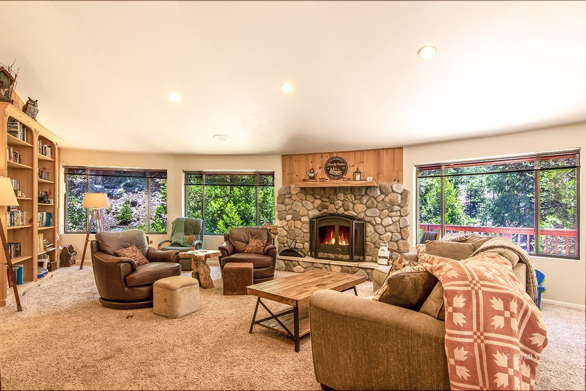 24625 Baldy Road Idyllwild, CA 92549 - Photo 8 of 80 a living room with furniture a fireplace and a floor to ceiling window