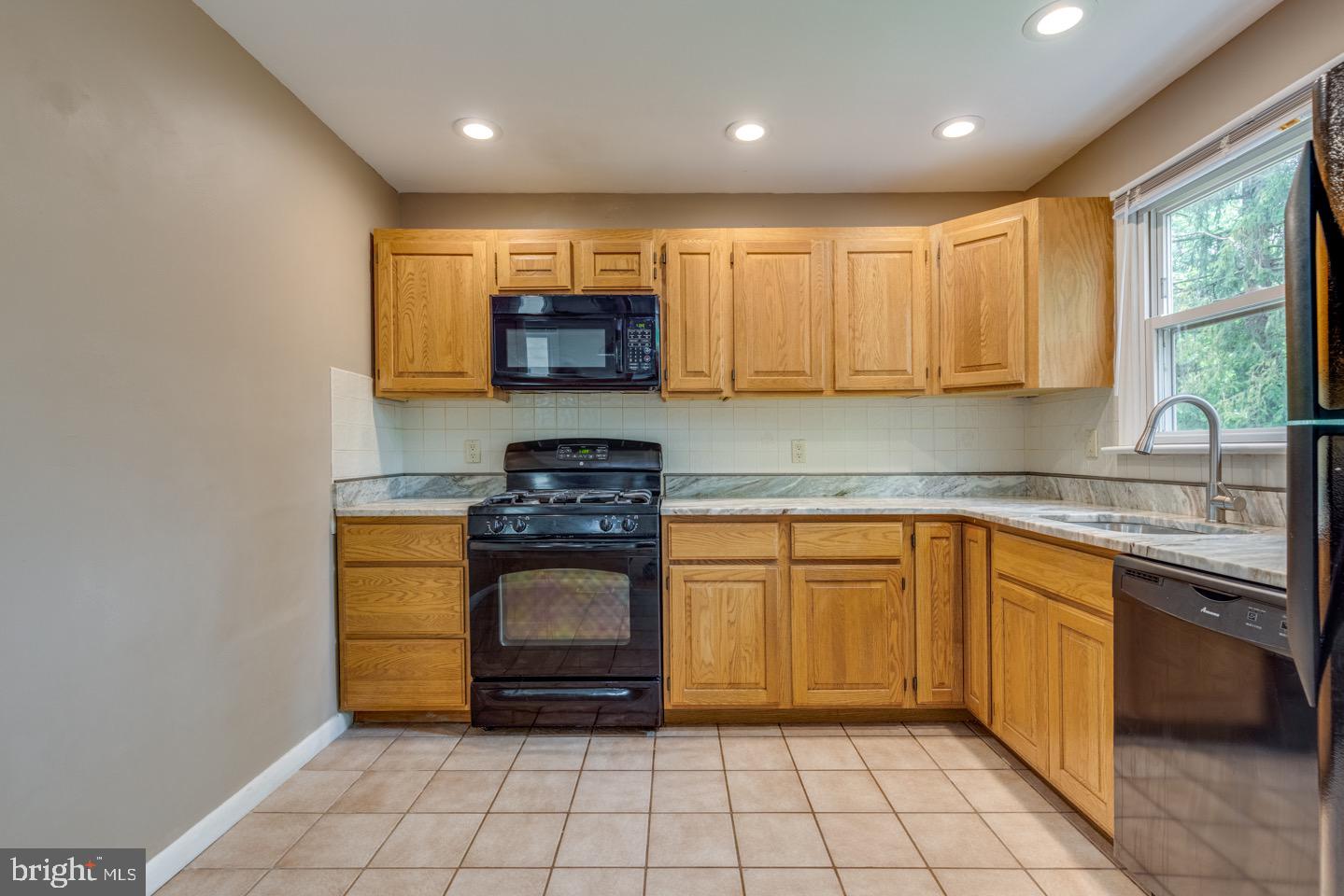 601 Pardee Lane Haddonfield, NJ 08033 - Photo 16 of 37 a kitchen with stainless steel appliances granite countertop a stove a sink and a microwave