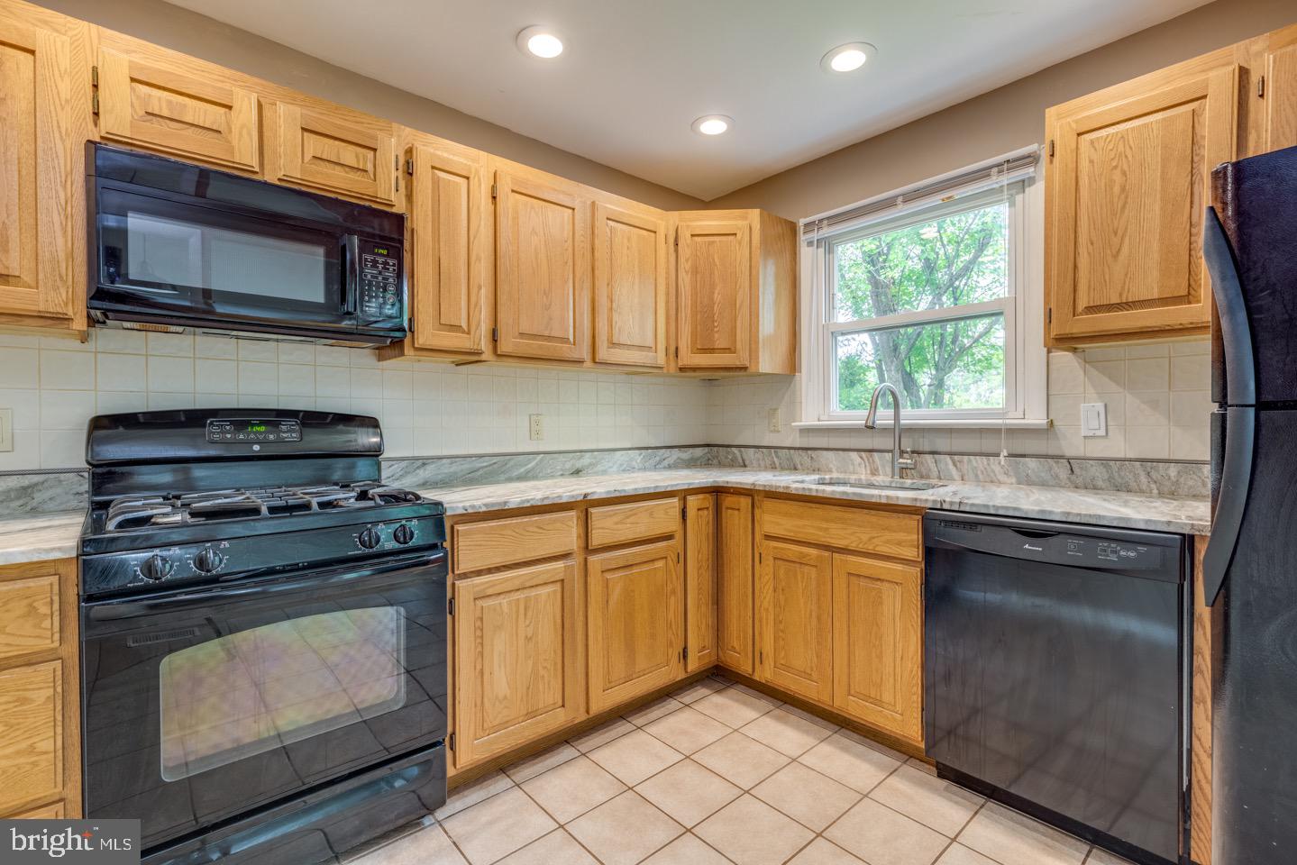 601 Pardee Lane Haddonfield, NJ 08033 - Photo 17 of 37 a kitchen with stainless steel appliances granite countertop white cabinets granite counter tops and a window