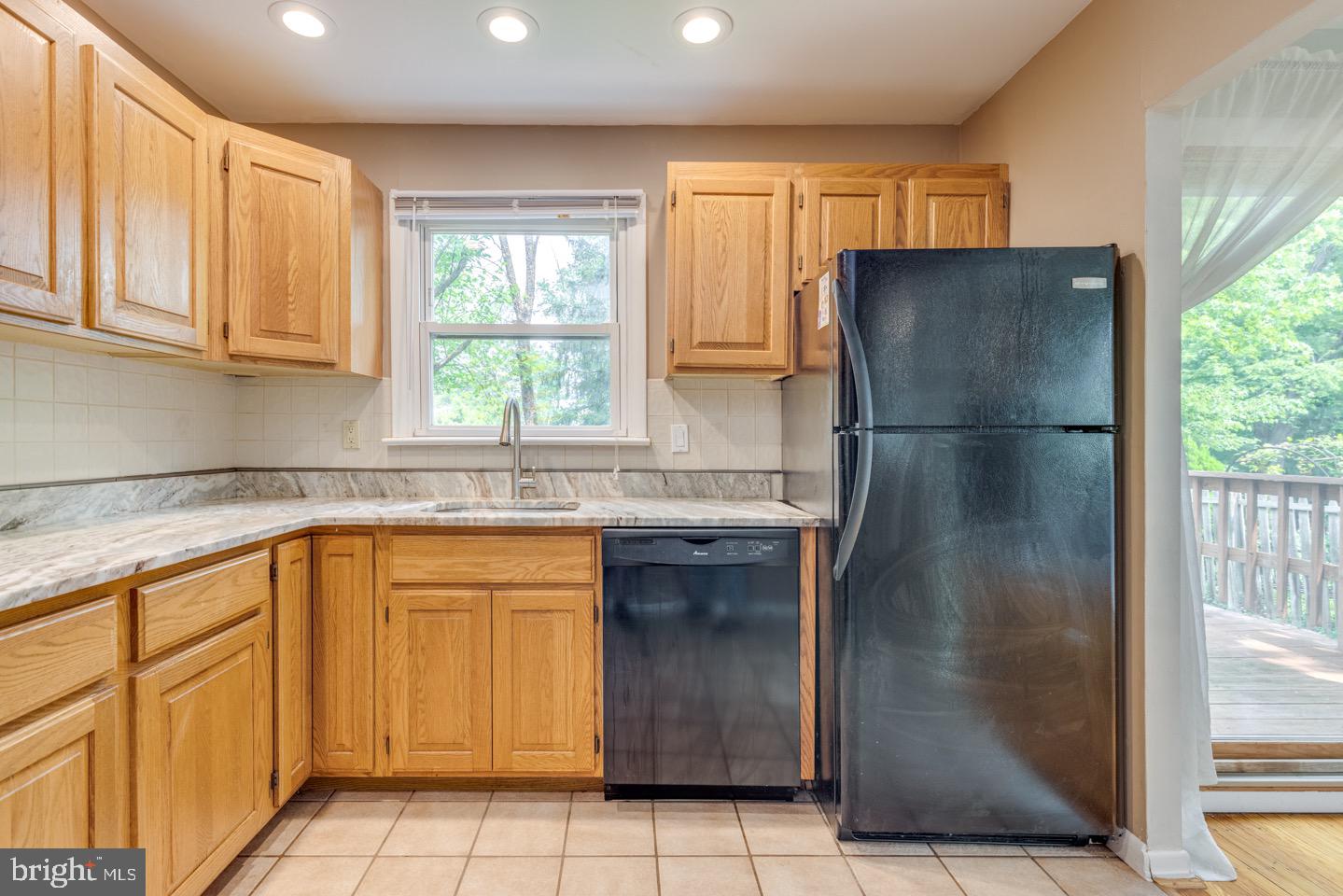 601 Pardee Lane Haddonfield, NJ 08033 - Photo 18 of 37 a kitchen with a refrigerator a sink and cabinets