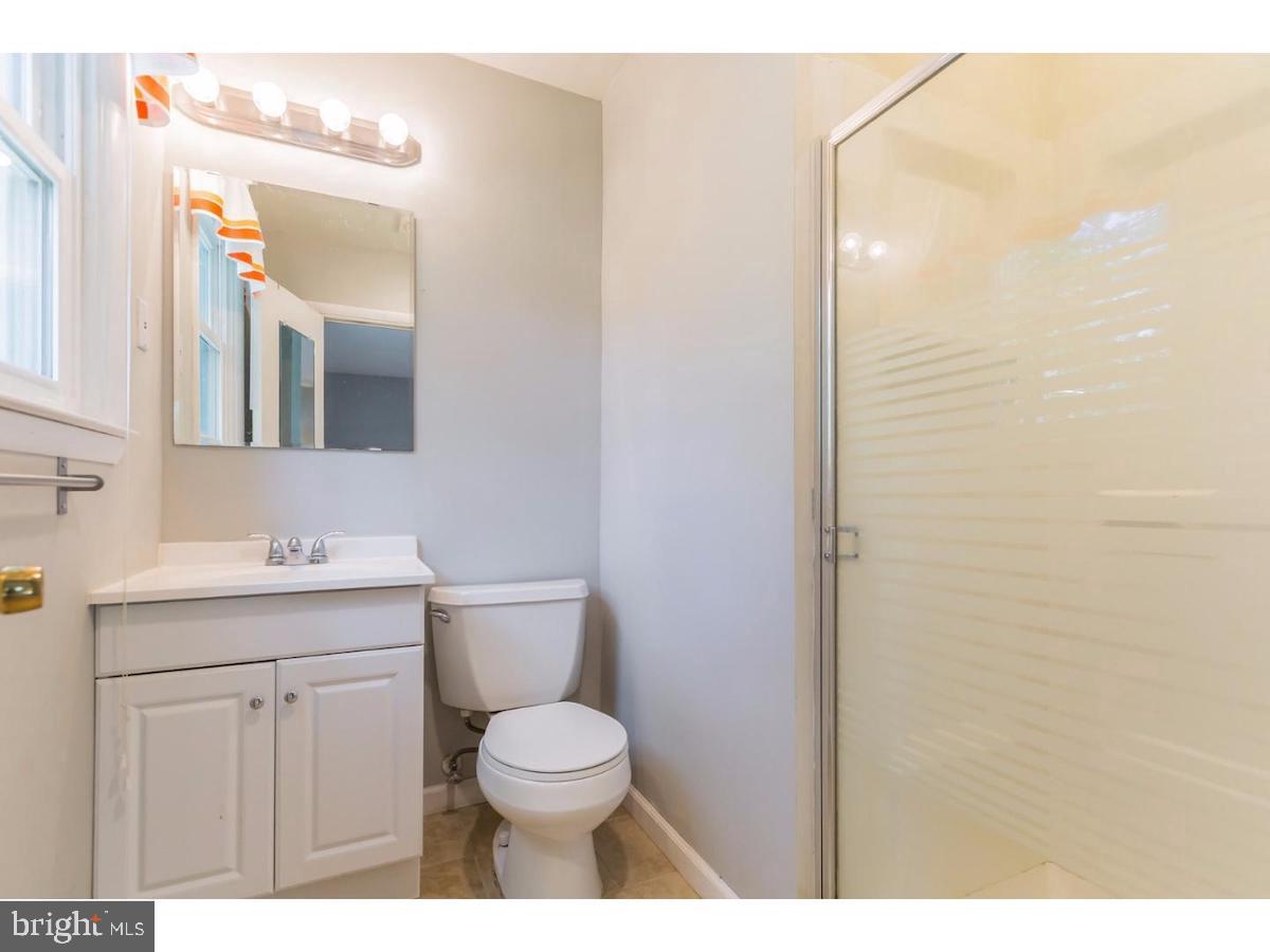 601 Pardee Lane Haddonfield, NJ 08033 - Photo 24 of 37 a bathroom with a toilet a sink a vanity and mirror