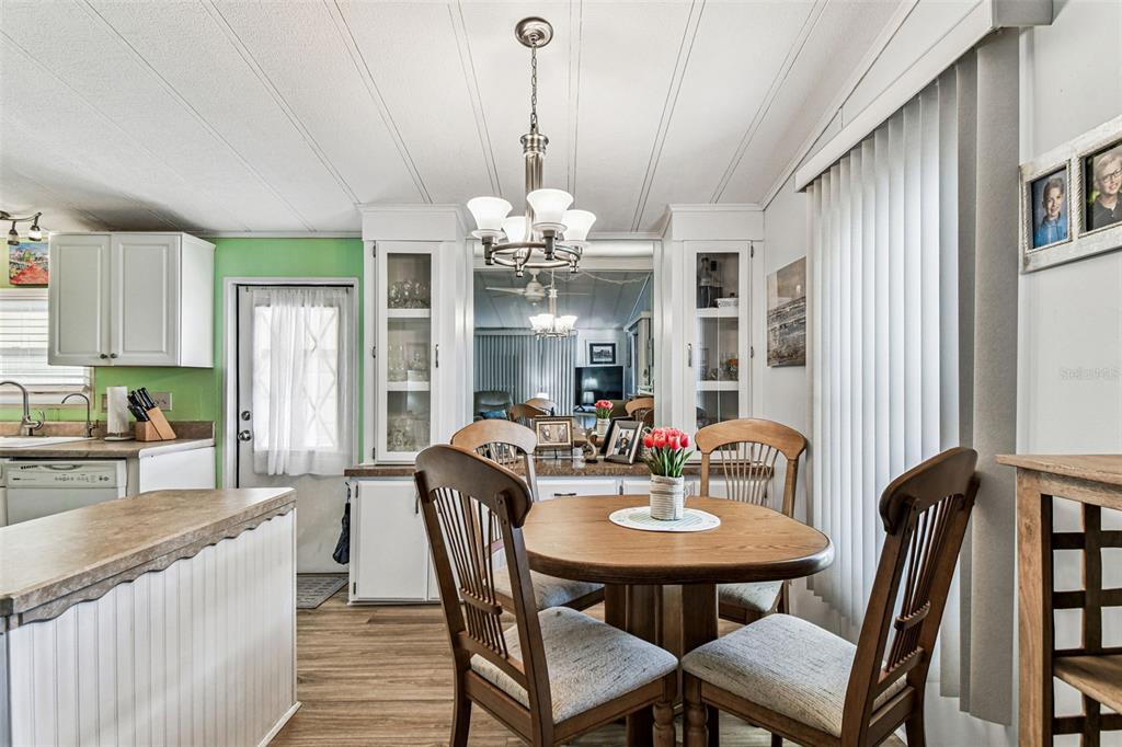12501 Ulmerton Road, Unit 71 Largo, FL 33774 - Photo 15 of 75 a view of a a dining room with furniture window and wooden floor