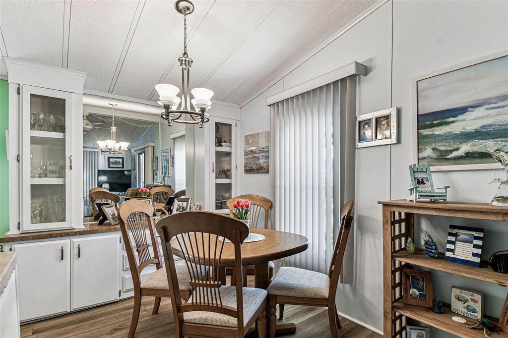 12501 Ulmerton Road, Unit 71 Largo, FL 33774 - Photo 16 of 75 a dining room with furniture a chandelier and window