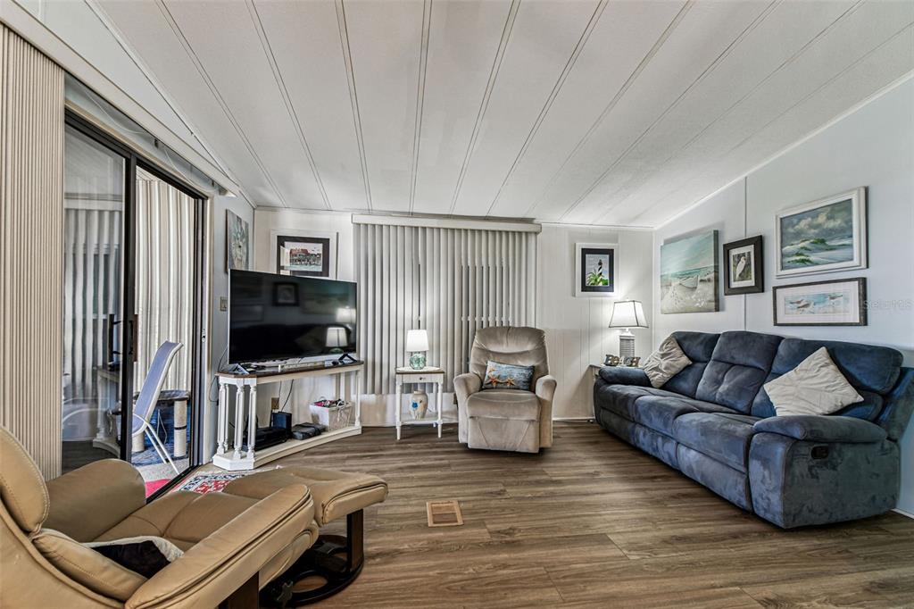 12501 Ulmerton Road, Unit 71 Largo, FL 33774 - Photo 19 of 75 a living room with furniture and a flat screen tv