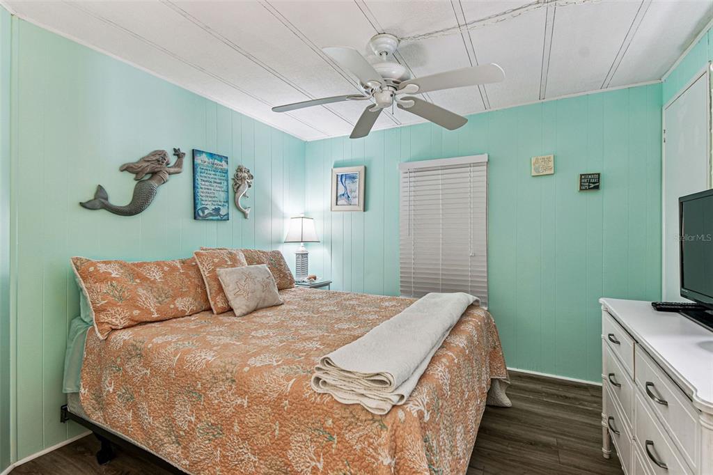 12501 Ulmerton Road, Unit 71 Largo, FL 33774 - Photo 26 of 75 a bedroom with a bed and a flat tv screen on dresser