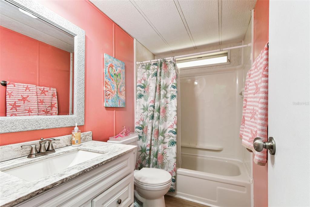 12501 Ulmerton Road, Unit 71 Largo, FL 33774 - Photo 27 of 75 a bathroom with a granite countertop sink a toilet and shower