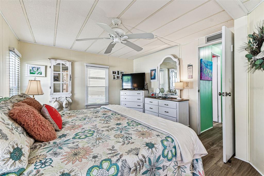 12501 Ulmerton Road, Unit 71 Largo, FL 33774 - Photo 31 of 75 a bedroom with a large bed a flat tv screen and large closet