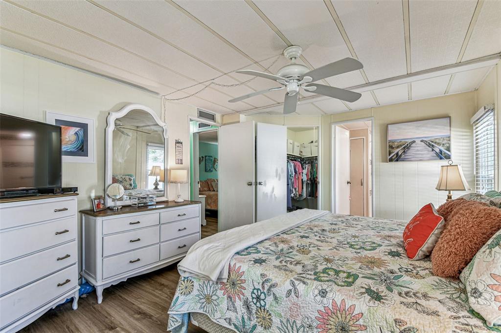 12501 Ulmerton Road, Unit 71 Largo, FL 33774 - Photo 35 of 75 a bedroom with a large bed and a flat tv screen on dresser