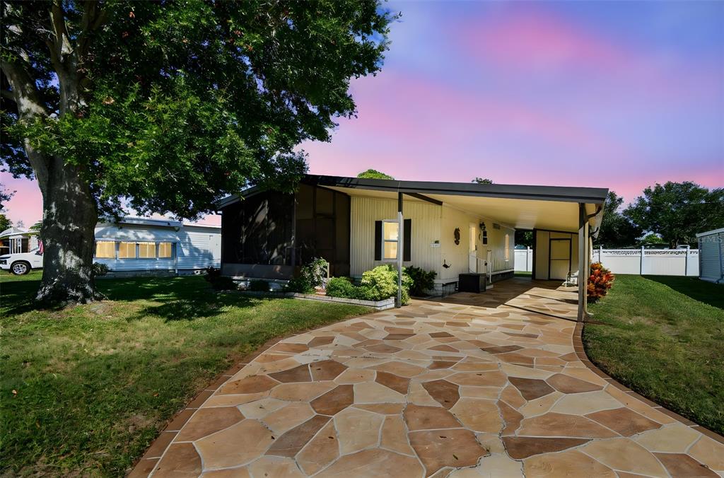 12501 Ulmerton Road, Unit 71 Largo, FL 33774 - Photo 44 of 75 a front view of a house with garden