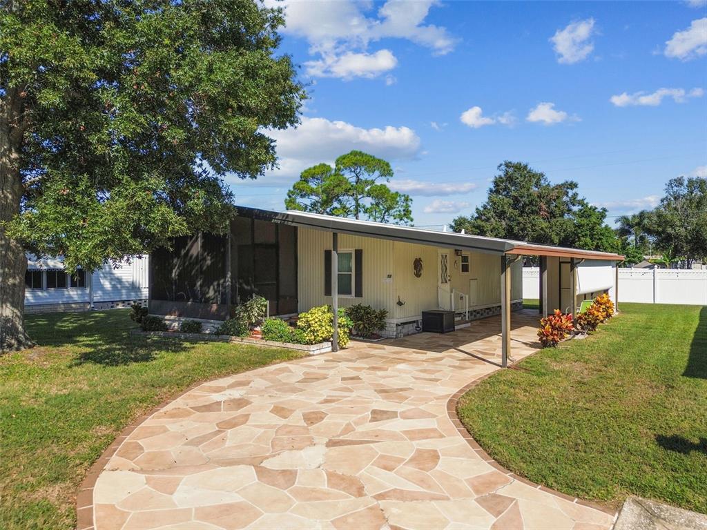 12501 Ulmerton Road, Unit 71 Largo, FL 33774 - Photo 46 of 75 a backyard of a house with yard and outdoor seating