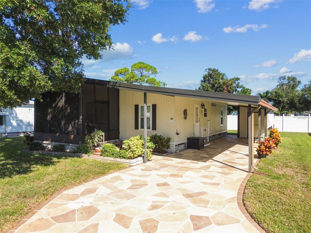 12501 Ulmerton Road, Unit 71 Largo, FL 33774 - Photo 47 of 75 a front view of a house with a yard