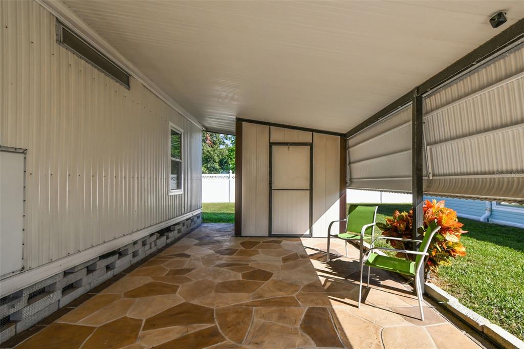12501 Ulmerton Road, Unit 71 Largo, FL 33774 - Photo 5 of 75 a backyard of a house with table and chairs