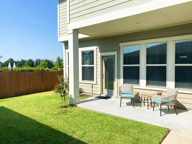 a house view with a sitting space and garden