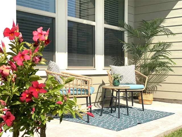 a view of a tables and chairs and table in a back yard of the house