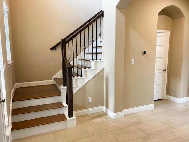 a view of entryway with wooden floor and a front door