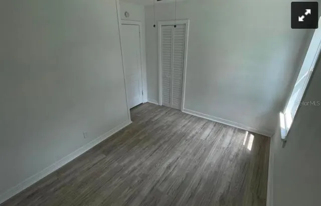 a view of wooden floor and windows in a room