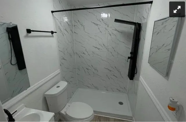 a bathroom with a shower and toilet