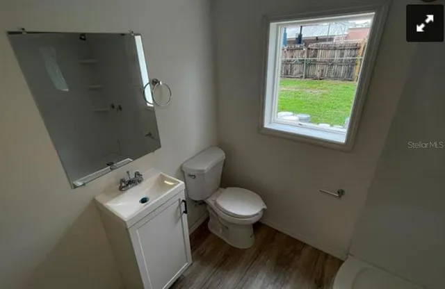 a white toilet sitting next to a bathroom sink