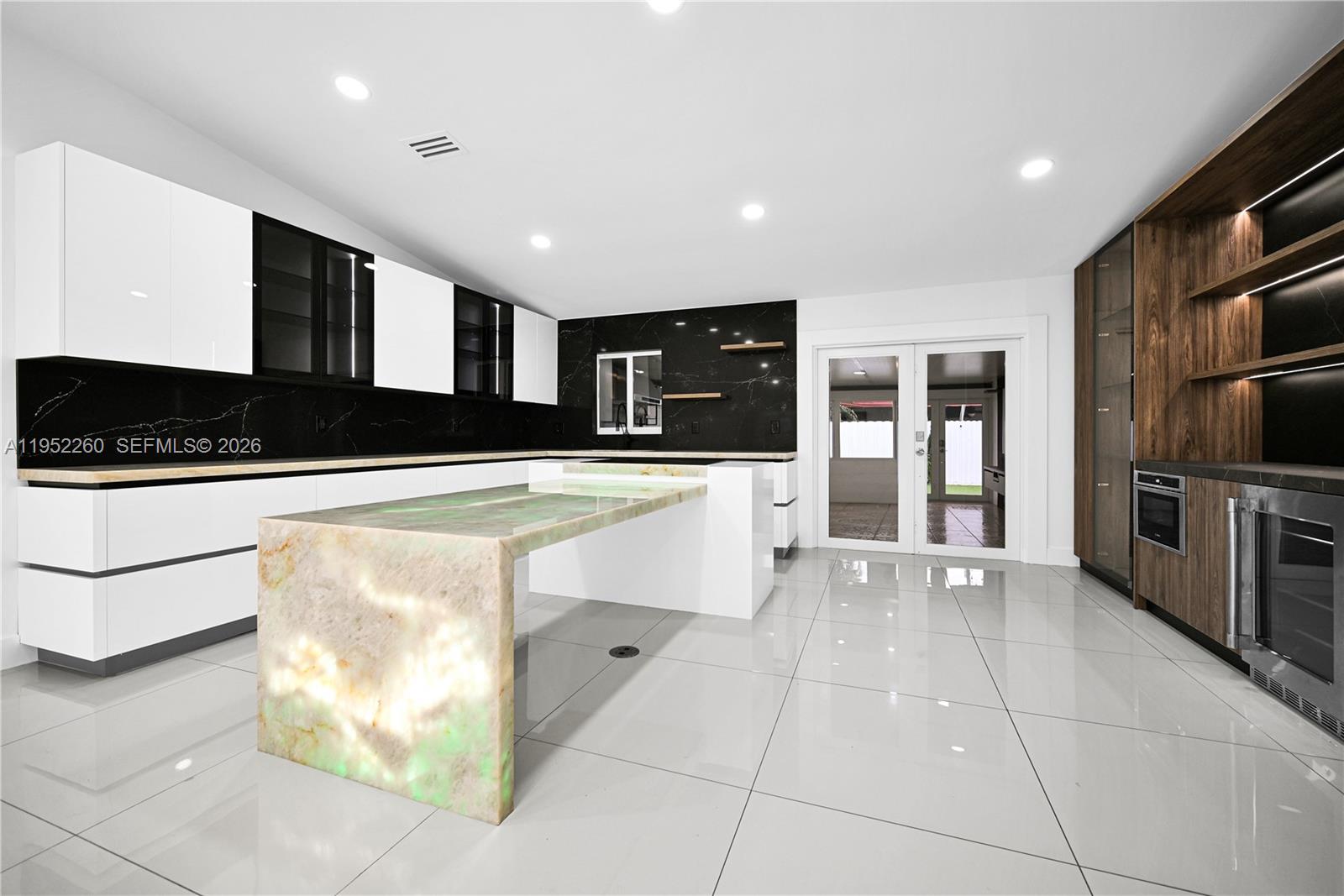 13284 Southwest 39th Street Miami, FL 33175 - Photo 11 of 67 a view of a kitchen with stainless steel appliances kitchen island granite countertop a refrigerator and a stove top oven