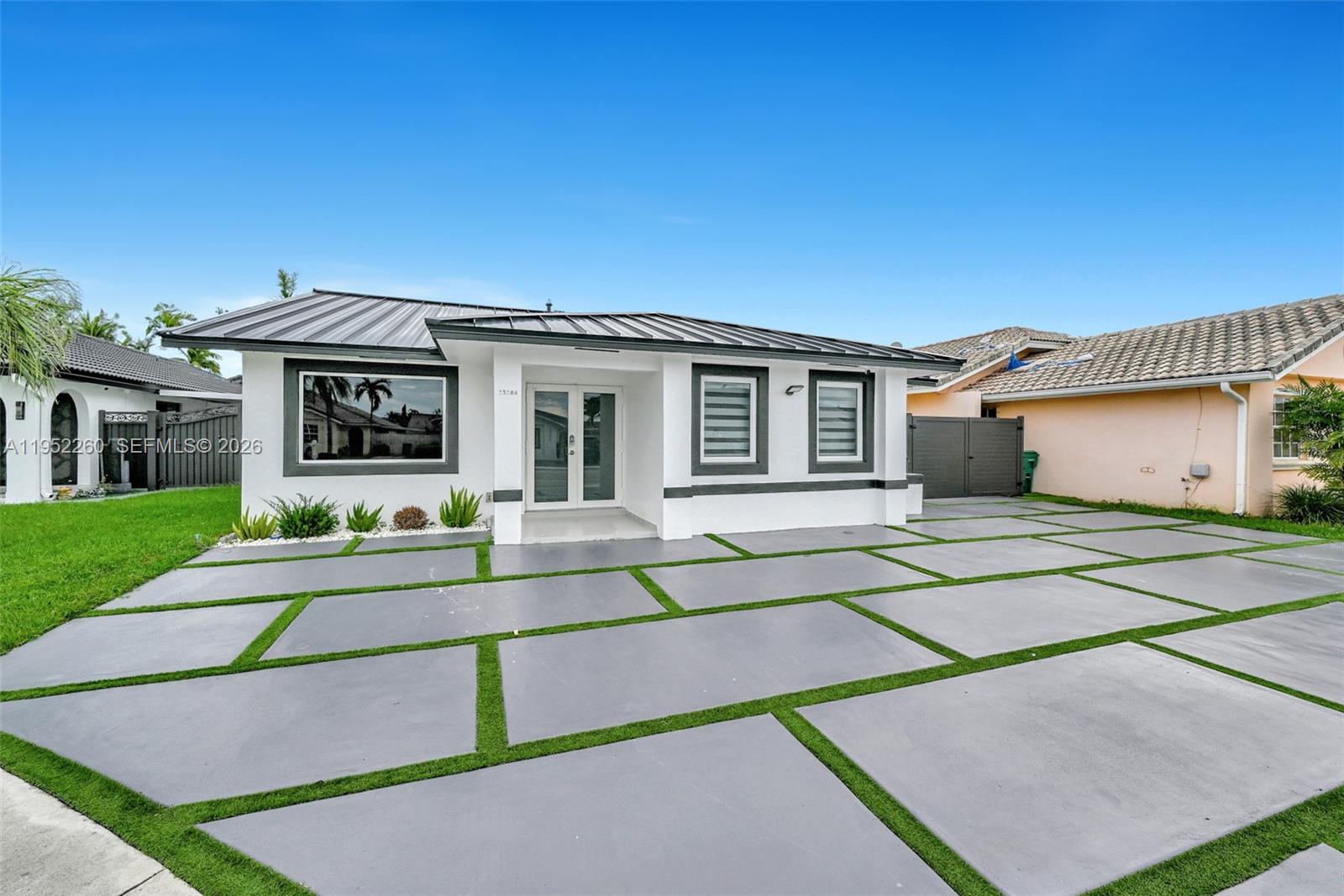 13284 Southwest 39th Street Miami, FL 33175 - Photo 3 of 67 a view of a white house with a big yard and large tree