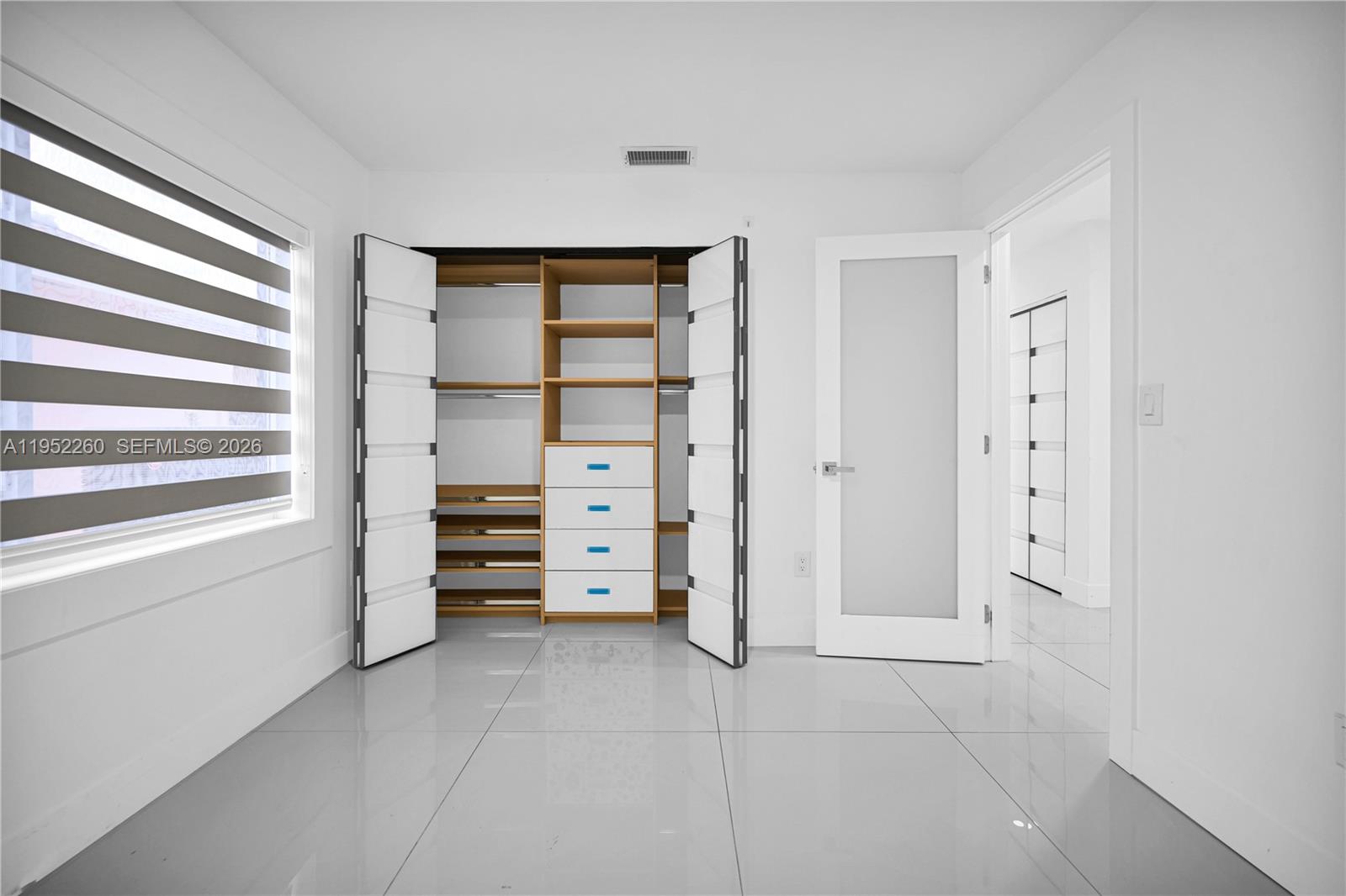 13284 Southwest 39th Street Miami, FL 33175 - Photo 36 of 67 a view of walk in closet with clothes and shoes