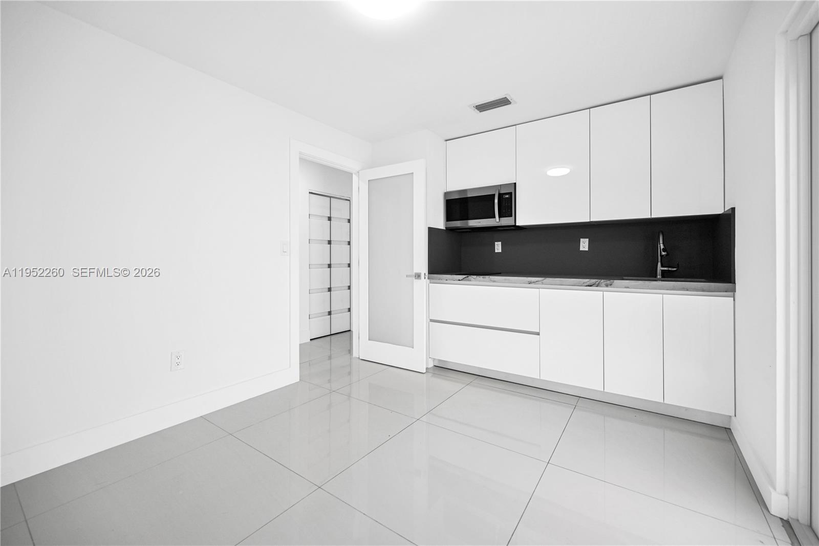13284 Southwest 39th Street Miami, FL 33175 - Photo 38 of 67 a kitchen with a sink and white cabinets