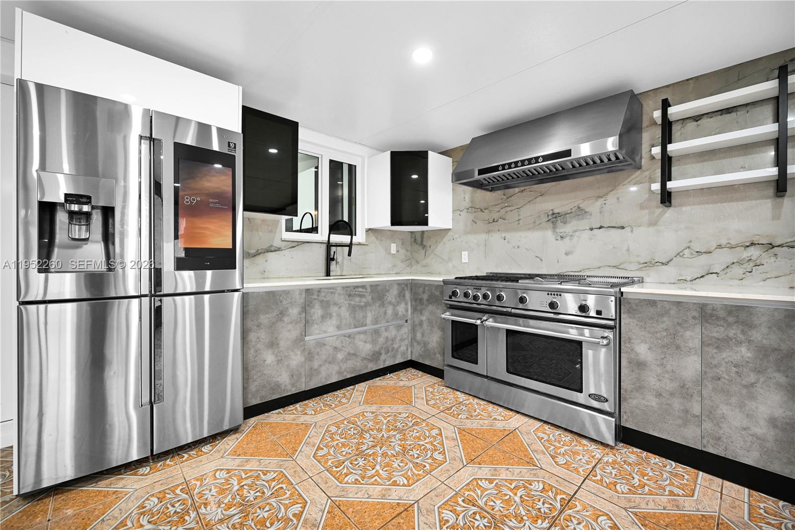 13284 Southwest 39th Street Miami, FL 33175 - Photo 54 of 67 a kitchen with stainless steel appliances granite countertop a stove a sink and a refrigerator