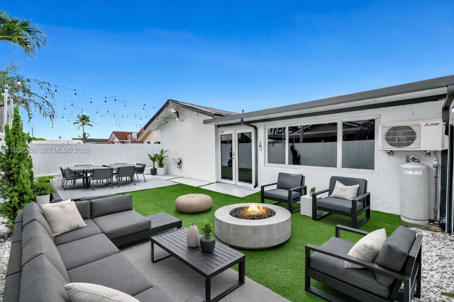 13284 Southwest 39th Street Miami, FL 33175 - Photo 55 of 67 a view of an house and patio with couches chair and grass