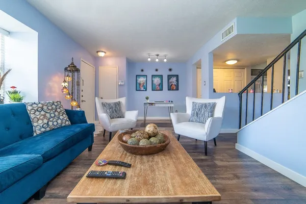 a living room with furniture and a rug